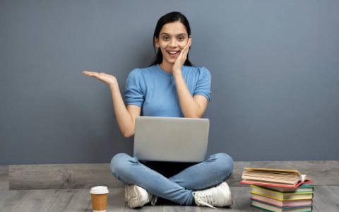 Girl Sitting on floor and using laptop to learn Last-Minute PTE-A Tips