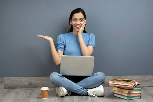 Girl Sitting on floor and using laptop to learn Last-Minute PTE-A Tips